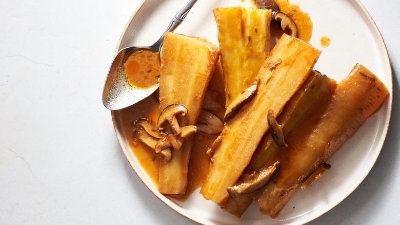 Braised parsnips on plate with mushrooms