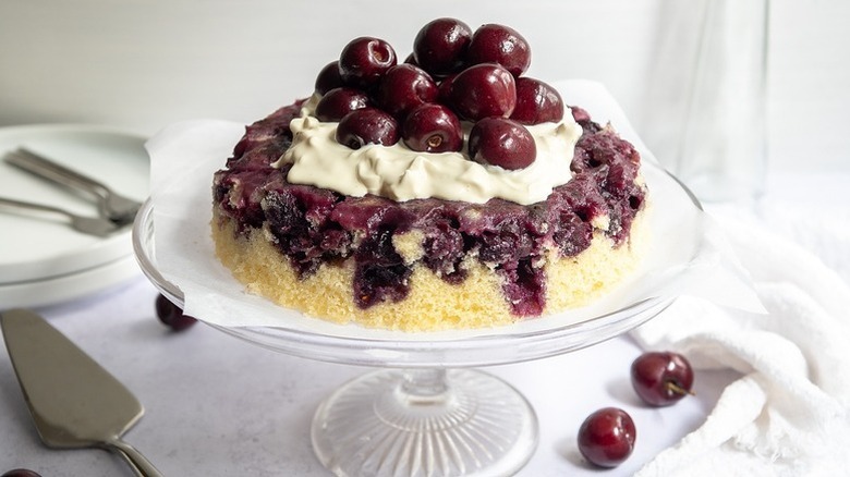 Cherry upside-down cake on glass cake stand