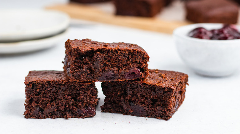 Three square slices of chocolate cherry cake