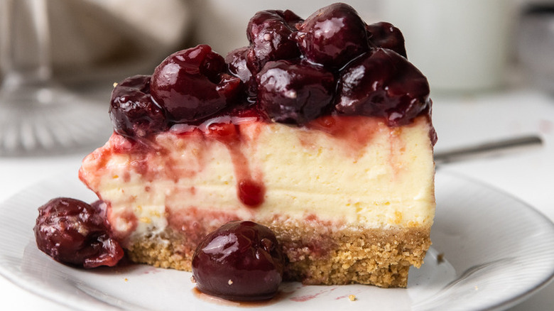 Slice of cherry cheesecake on plate
