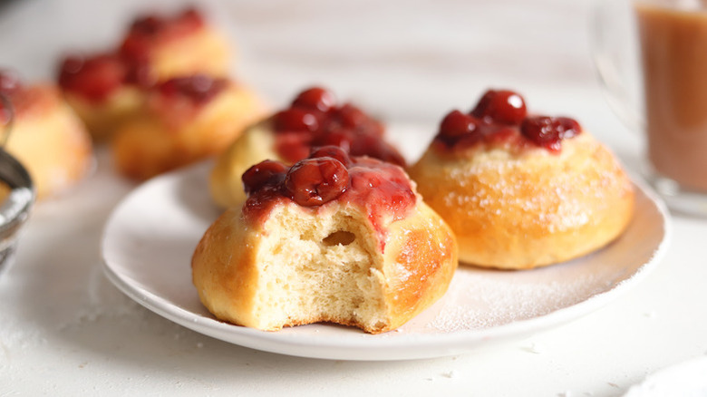 Cherry kolache buns on white plate