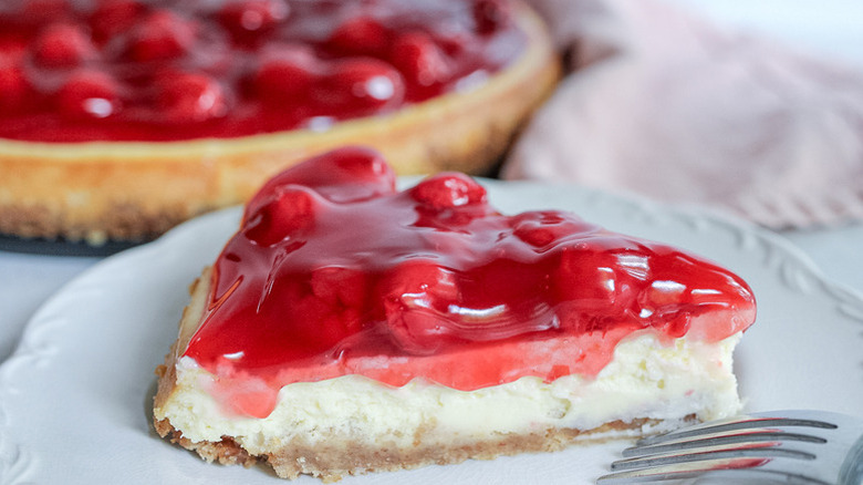 Slice of cherry cheesecake on plate