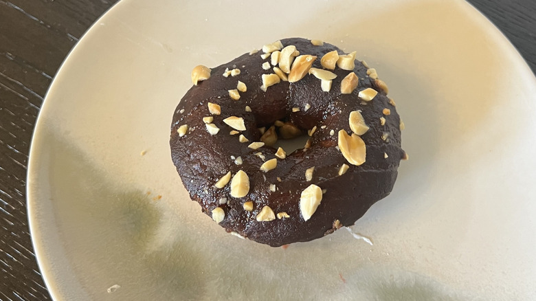 Duck Donuts Chocolate Caramel Crunch donut on plate.
