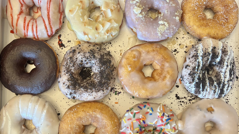 A dozen Duck Donuts in box.