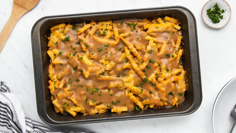 Classic Jersey disco fries topped with freshly chopped parsley served inside a black baking tray
