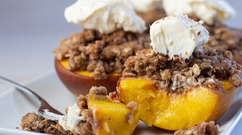 Close up of baked peaches with crumble topping
