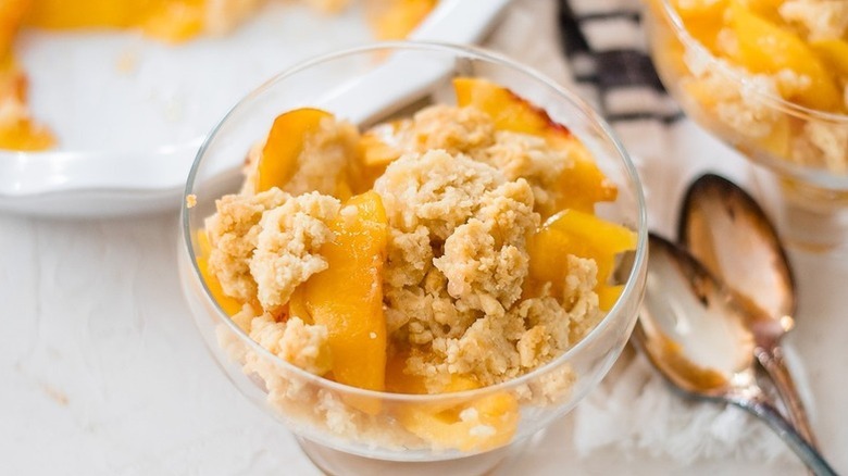 Portion of peach cobbler in dessert glass
