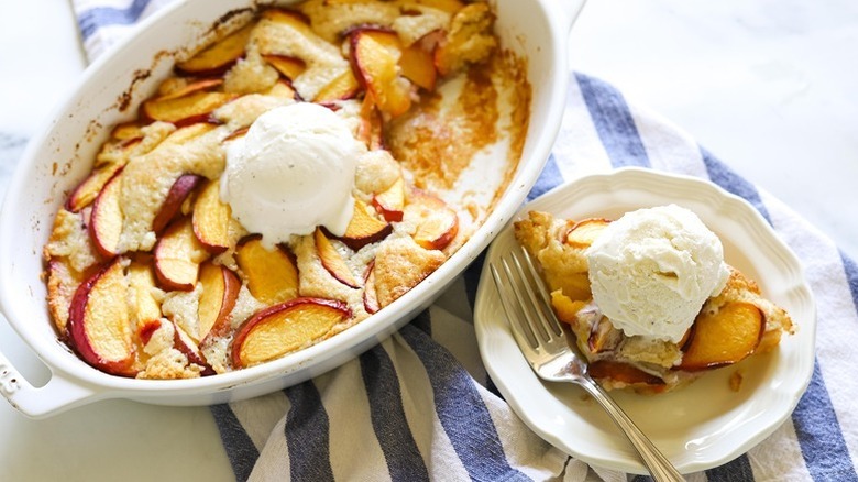 Peach cobbler served from baking dish onto plate