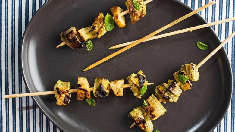 Pork-and-Pineapple Skewers on black plate