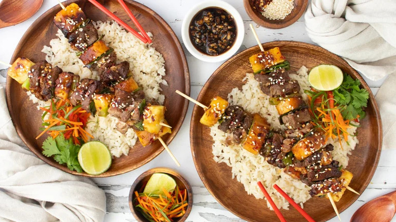 Simple Teriyaki-Glazed Steak Skewers on wooden plates