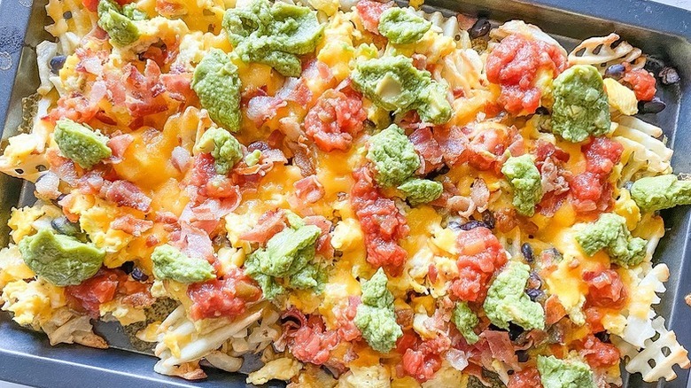 Breakfast waffle fry nachos topped with guacamole, cheese, and salsa