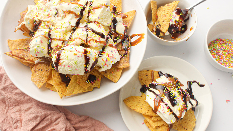 Bowls of tortilla chips topped with ice cream, chocolate sauce, and sprinkles