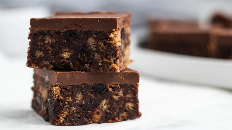 Two slices of chocolate tiffin stacked on top of one another