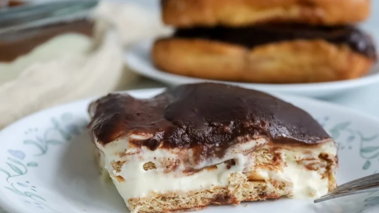 A slice of no-bake eclair cake on a decorative plate