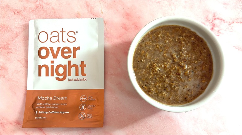 Bowl of Oats Overnight Mocha Dream next to packet on pink surface