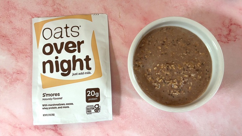Bowl of Oats Overnight S'mores next to packet on pink surface