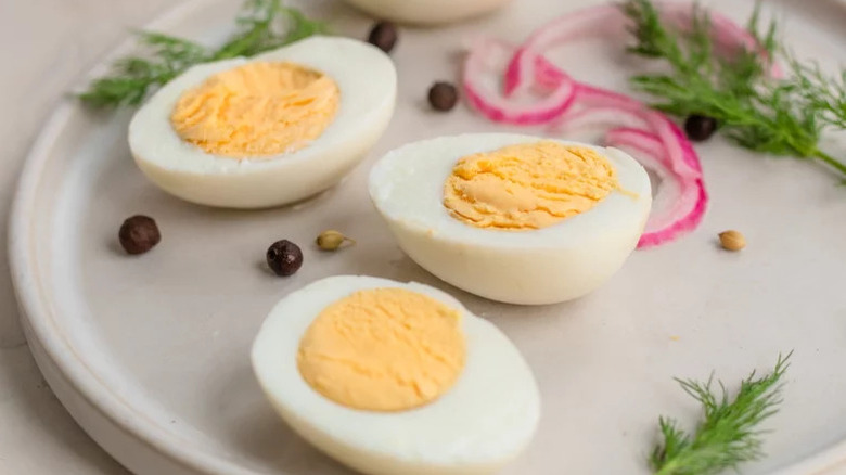 Classic Pickled Eggs on white plate with sprigs of dill