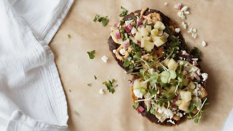 Pickled Apples on tostadas on parchment paper