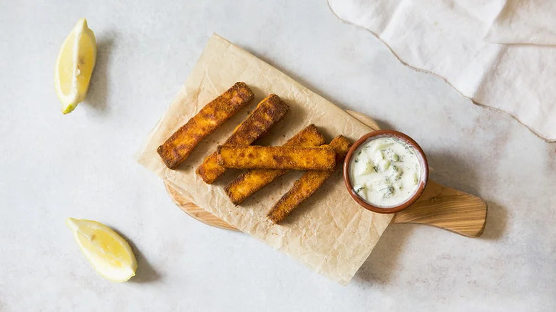 Crispy Air Fryer Paneer Sticks on wooden board with dipping sauce