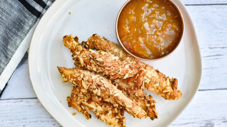 Crispy Air Fryer Pretzel Chicken Fries on white plate with dipping sauce
