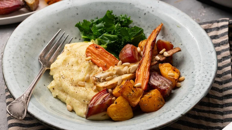 Roasted Root Vegetable Polenta on plate with steamed kale