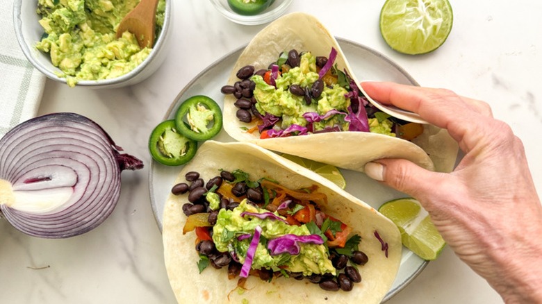 Holding black bean fajitas