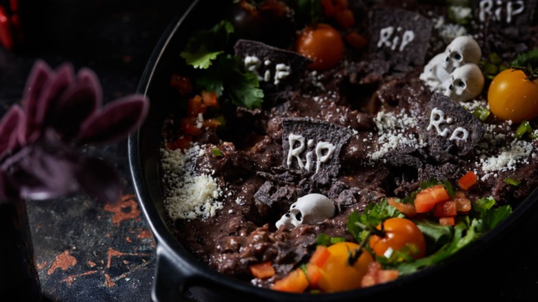 Graveyard bean dip in black bowl
