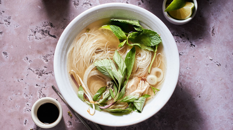 Bowl of chicken pho with fresh mint and Thai basil