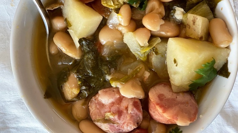 Bowl of vegetable, bean, and sausage soup