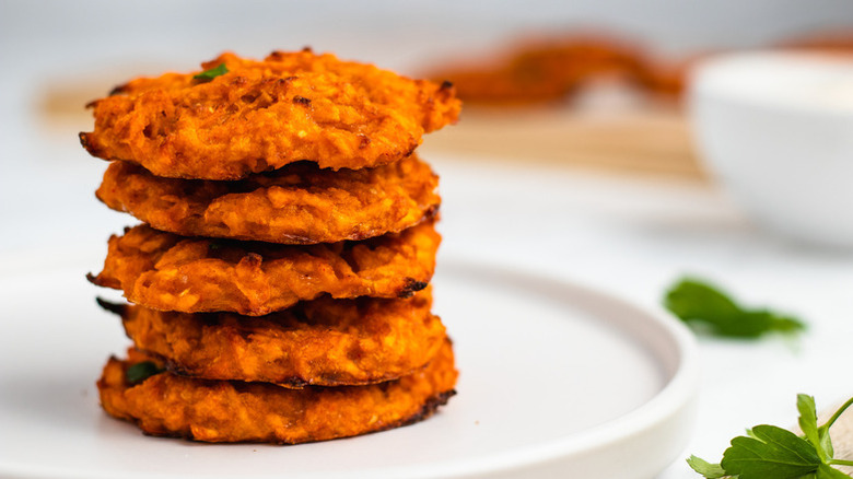 Stack of sweet potato fritters on plate