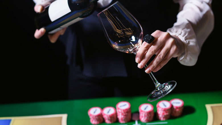 Pouring wine at a poker table