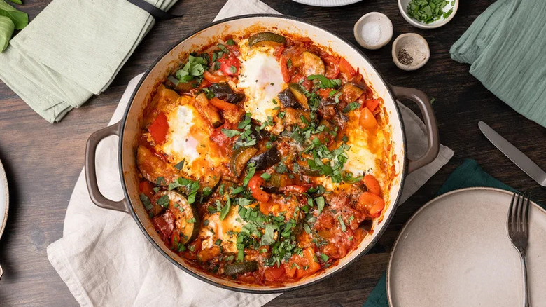 Breakfast Ratatouille Shakshuka in skillet on kitchen towel