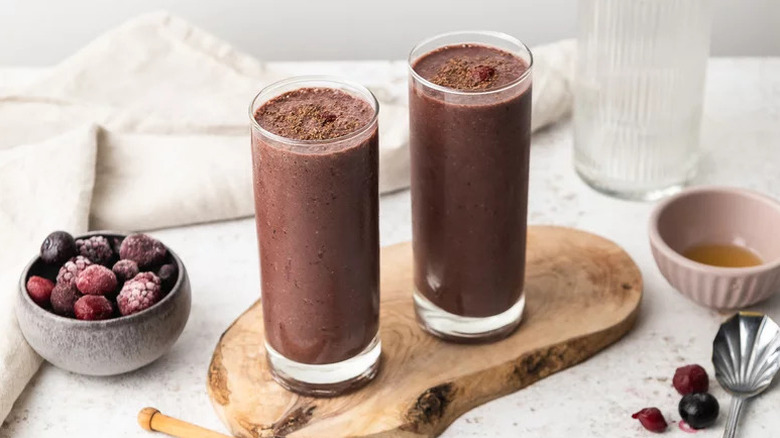 Healthy Black Forest Smoothie in two glasses on wooden board