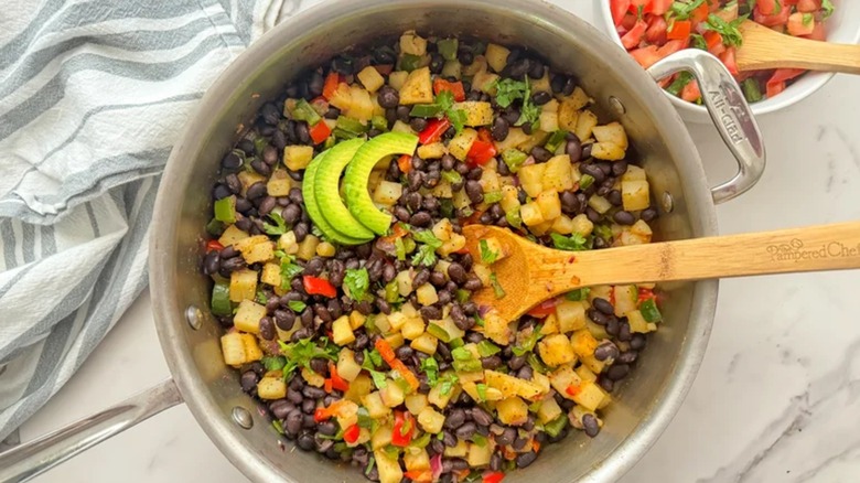 Poblano Potato Breakfast Hash in skillet with wooden spoon