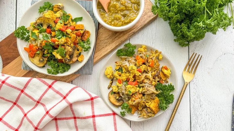 Plant-Based 'Egg'y Breakfast Casserole on two white plates with gold fork