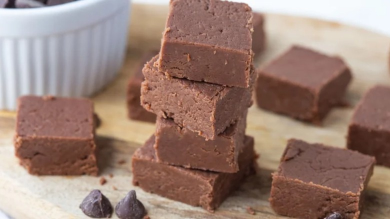 Stack of fudge squares on wooden surface