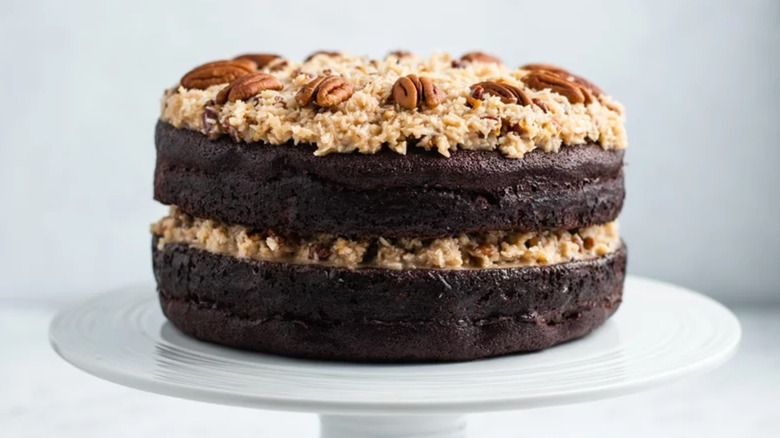 German chocolate cake on white cake stand