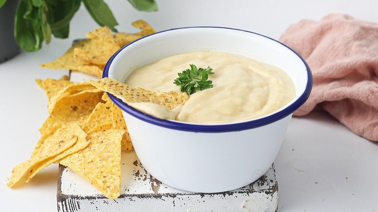 Bowl of nacho cheese served with tortilla chips
