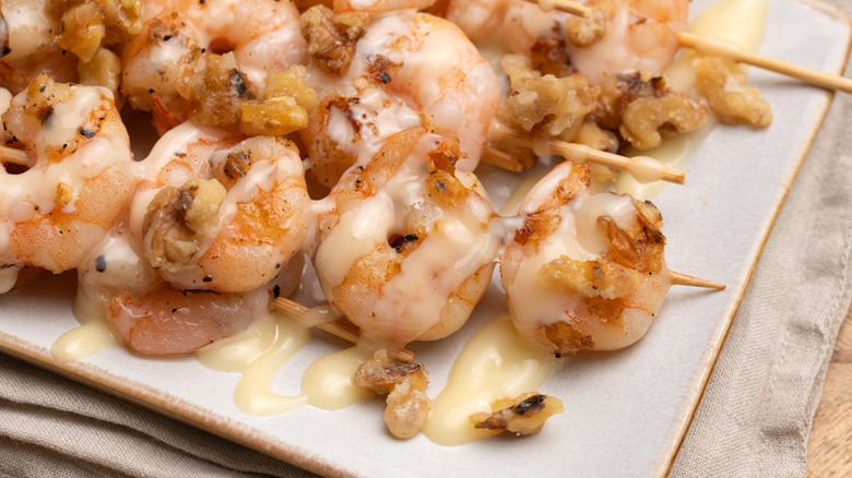 Grilled honey walnut shrimp skewers on plate