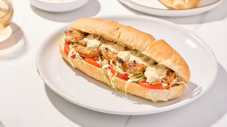 Grilled shrimp po-boy sandwich on plate