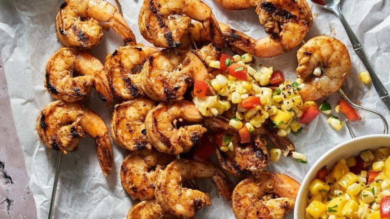 Grilled shrimp skewers with corn and mango salsa