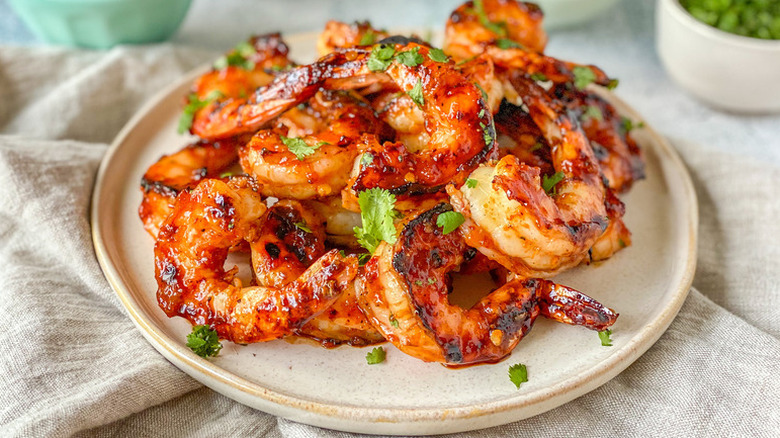 Pile of spicy grilled shrimp on plate