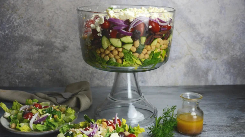 Greek-Style Seven-Layer Salad in trifle bowl on countertop