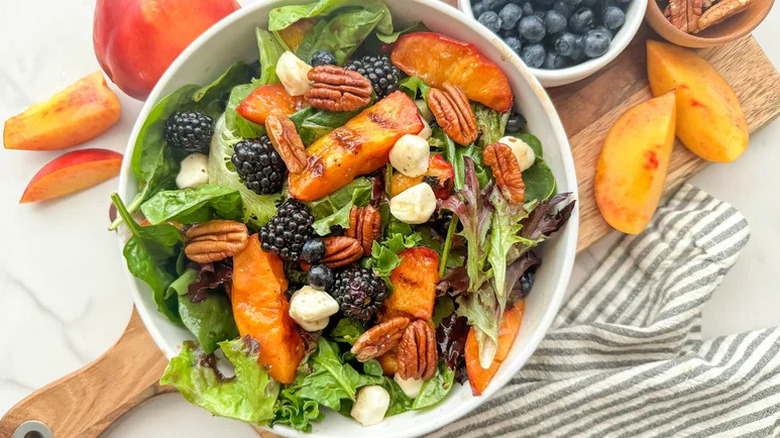 Grilled Nectarine Salad in white bowl on wooden board