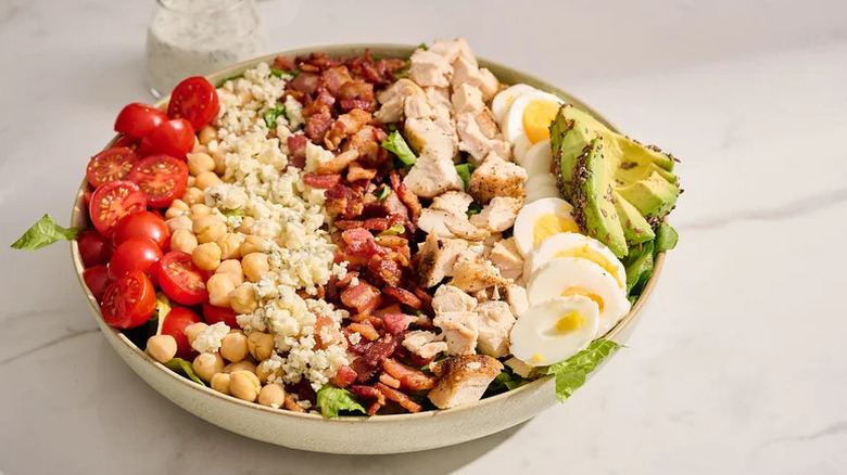 Protein-Packed Cobb Salad in white bowl on countertop