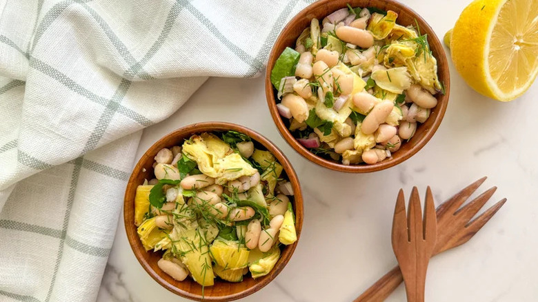 Roasted Artichoke and White Bean Salad in two small wooden bowls