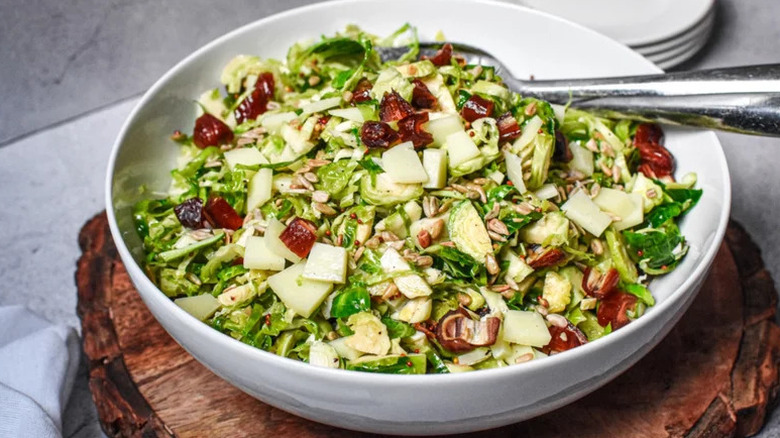 Shaved Brussels Sprouts Salad in large white serving bowl