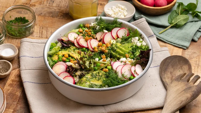 Spring-Forward Chickpea Salad in white bowl on towel