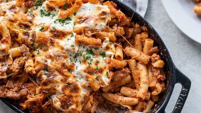 Cheesy baked ziti in black baking dish