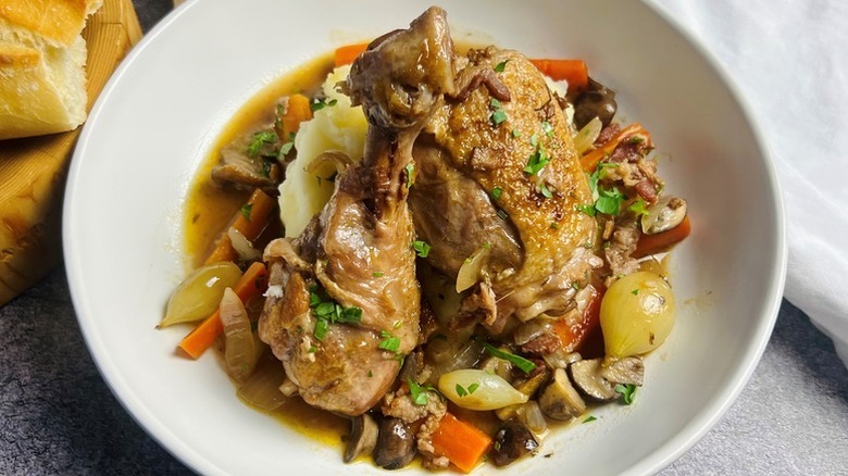 Coq au vin served in white bowl